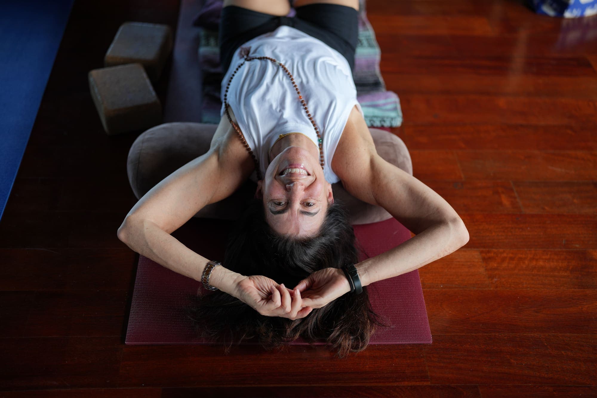 A person smiling with compassion during a yoga practice